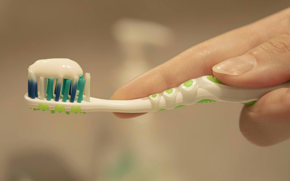 Toothbrush with toothpaste made with sorbitol, glycerin and CMC binders
